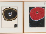 two framed pictures of donuts on display in a room