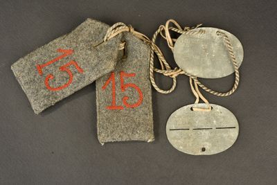 three tags with numbers on them hang on a string