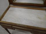 a marble top vanity with a mirror on top of it