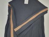 the sweater has a brown stripe on the side and a black sweater with a tan stripe on the side