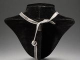 a black hat with a white ribbon tied to it