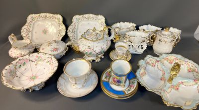 many different types of porcelain dishes and cups on the table