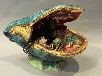 a small decorative shell with shells inside of it