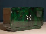 a green cabinet sitting on top of a wooden table