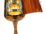 a table lamp that has a glass shade on it