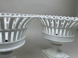 two white vases that are sitting on a table