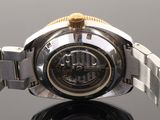 a close up of a watch on a black surface