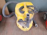 a yellow vacuum cleaner sitting on the floor next to other tools