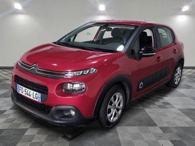 the red citrole is parked on a checkered floor