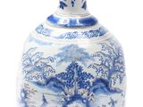 a blue and white vase sitting on a white surface