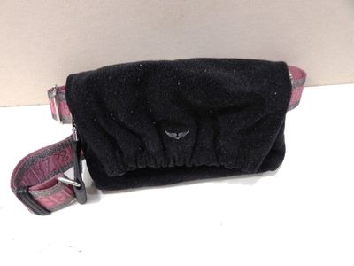 a small black bag with a pink handle on a white table