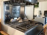 an image of a commercial kitchen with a large grill