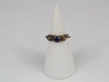 an image of a ring with a blue stone on it