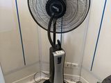 a fan that is sitting on the floor in the corner of a room