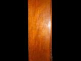 a tall wooden cabinet with a mirror on top of it
