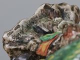 a figurine of a dog laying down on a pillow