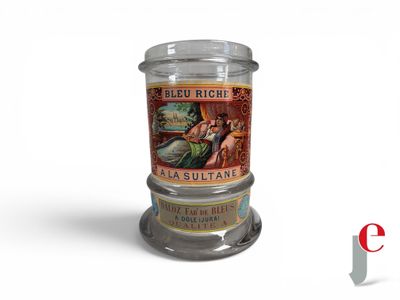 a glass jar with a label on it sitting on a table