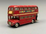 a red double decker bus that is sitting on a table