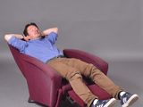 a man that is sitting in a chair with his feet up