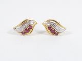 a pair of ruby and diamond earrings