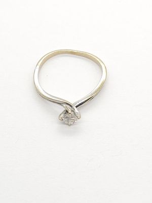 a picture of a diamond ring on a white surface