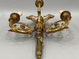 an image of a gold candle holder with three candles on it