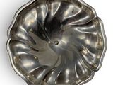 a silver plate with a flower shaped design on it