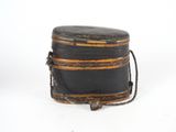 a black box with a rope around it on a white surface