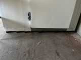 a white refrigerator sitting in the corner of a room