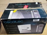 two boxes of electronic equipment sitting on top of a wooden table