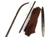 a knife, a cane, and a piece of cloth on a white surface