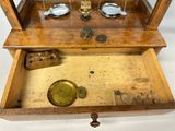 a wooden display case with a clock inside of it