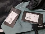 two tags on the back of a jacket with a name tag attached to it