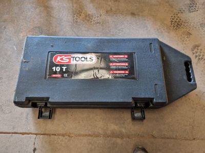 a small tool box on the floor with a person standing next to it