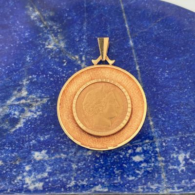 a gold coin is sitting on a blue marble slab