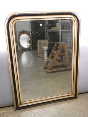 a mirror that is sitting on the floor in a room