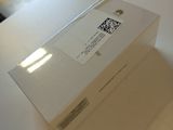 a white box sitting on a table with a cell phone in it