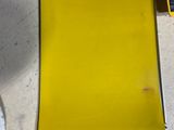 a yellow piece of paper sitting on a table next to a pair of scissors