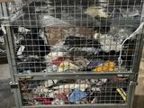 a metal cage filled with lots of trash in a warehouse