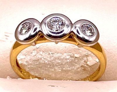 une bague en or sertie de trois diamants