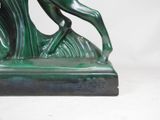 a statue of a horse that is standing on a base