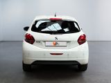 the rear end of a white car in a white room
