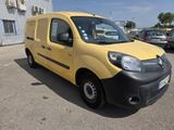 the yellow van is parked in a parking lot with other cars