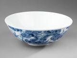 a blue and white bowl on a gray background