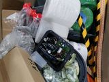 a cardboard box filled with assorted items and a cell phone