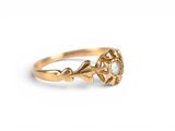 a close up of a gold ring with a pearl in it