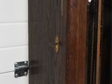 a close up of a wooden door with a chain on it
