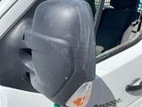 a white van with a side mirror on the side of it