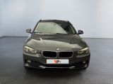 bmw 3 series saloone in a showroom with a license plate on the front of the car
