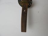 an old rusty door handle on the wall